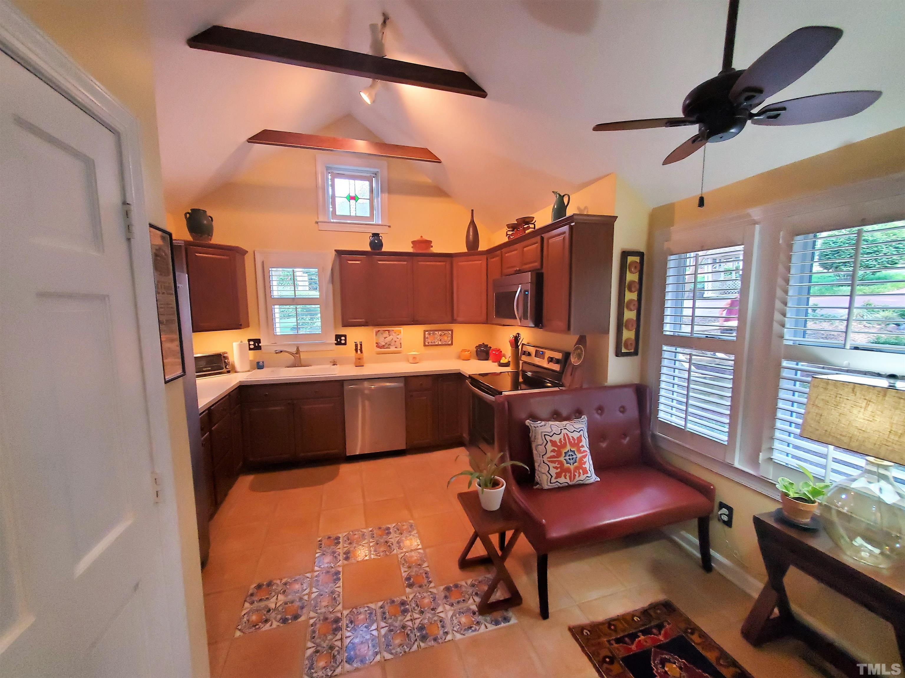 5741 Sentinel Drive Raleigh, NC 27609 - Photo 8 of 26 Kitchen features vaulted ceiling and exposed beams, and quartz counter tops. Fully remodeled in 2015