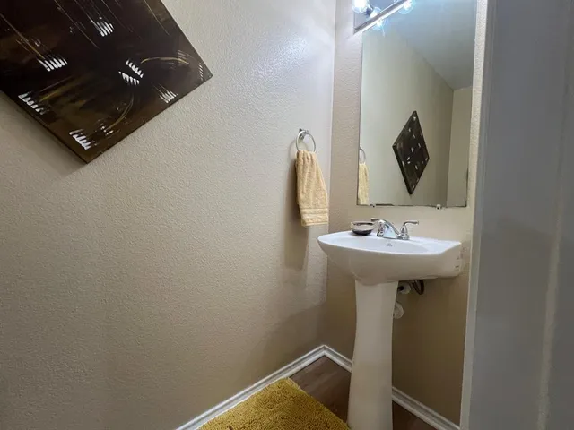 a bathroom with a sink and mirror