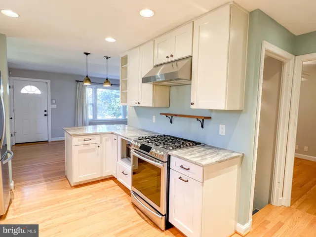 a kitchen with a stove a sink and a refrigerator