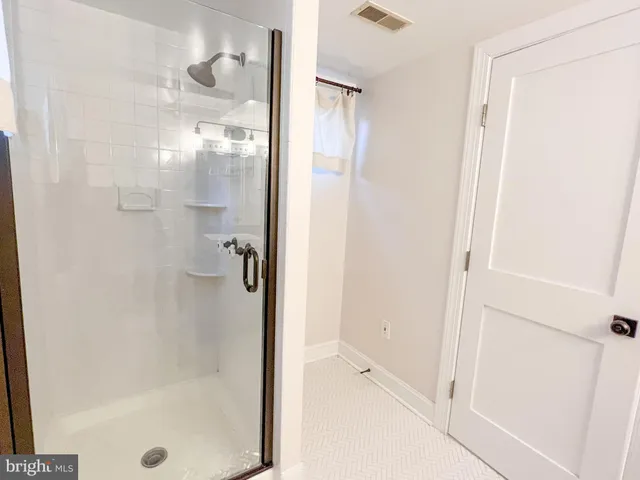 a bathroom with a glass shower door