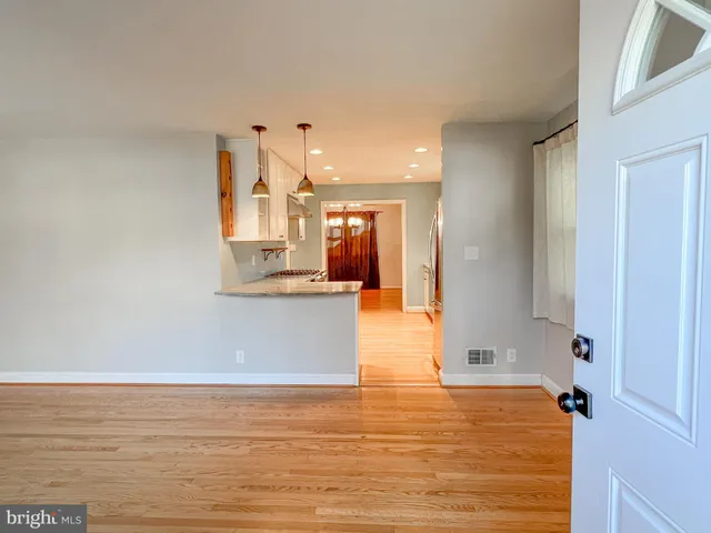 a view of a kitchen and an empty room
