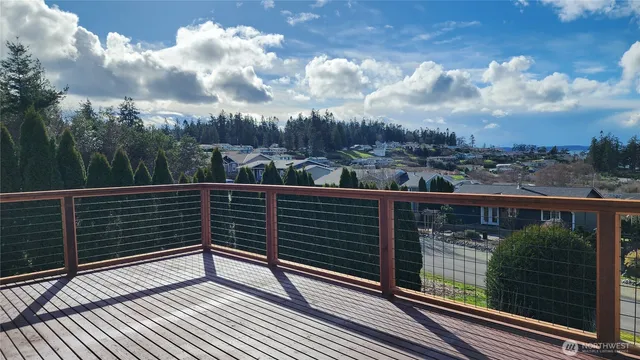 a view of a balcony with a floor to ceiling window and wooden floor