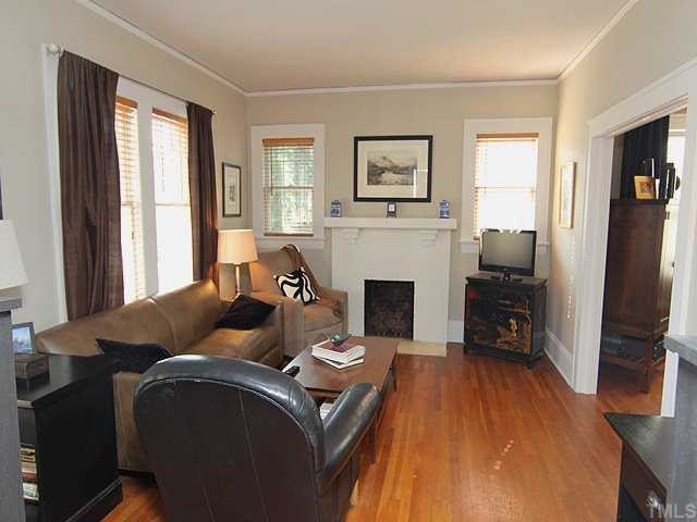 2215 Creston Road Raleigh, NC 27608 - Photo 3 of 14 a living room with furniture and a fireplace