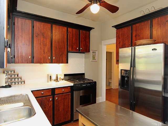 2215 Creston Road Raleigh, NC 27608 - Photo 6 of 14 a kitchen with stainless steel appliances granite countertop a refrigerator and a sink