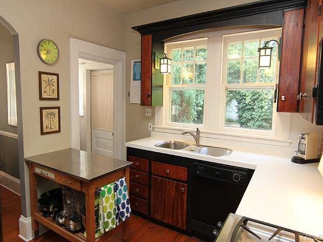 2215 Creston Road Raleigh, NC 27608 - Photo 7 of 14 a kitchen with a stove a sink and a refrigerator