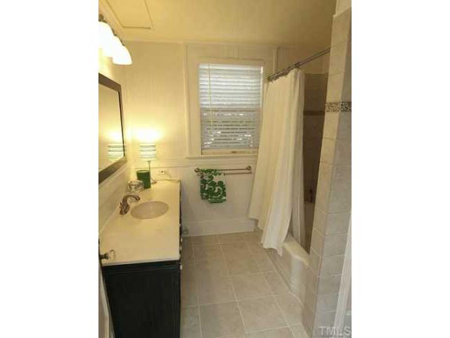 2215 Creston Road Raleigh, NC 27608 - Photo 10 of 14 a bathroom with a sink and a mirror