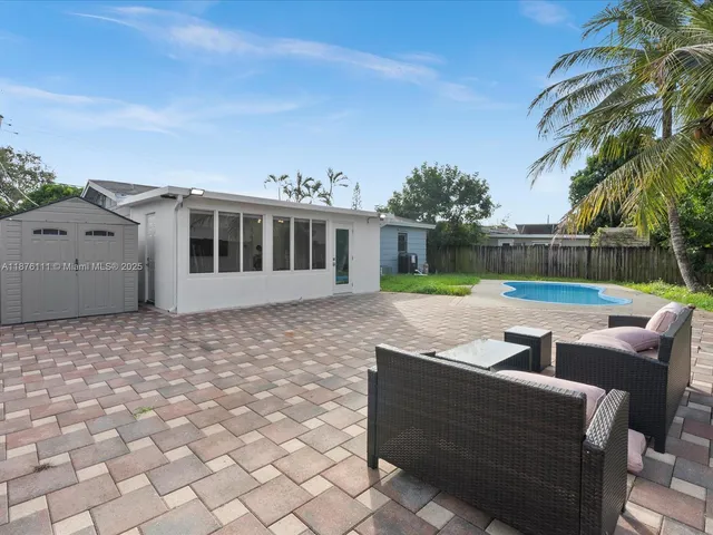 a view of swimming pool with outdoor seating and a yard