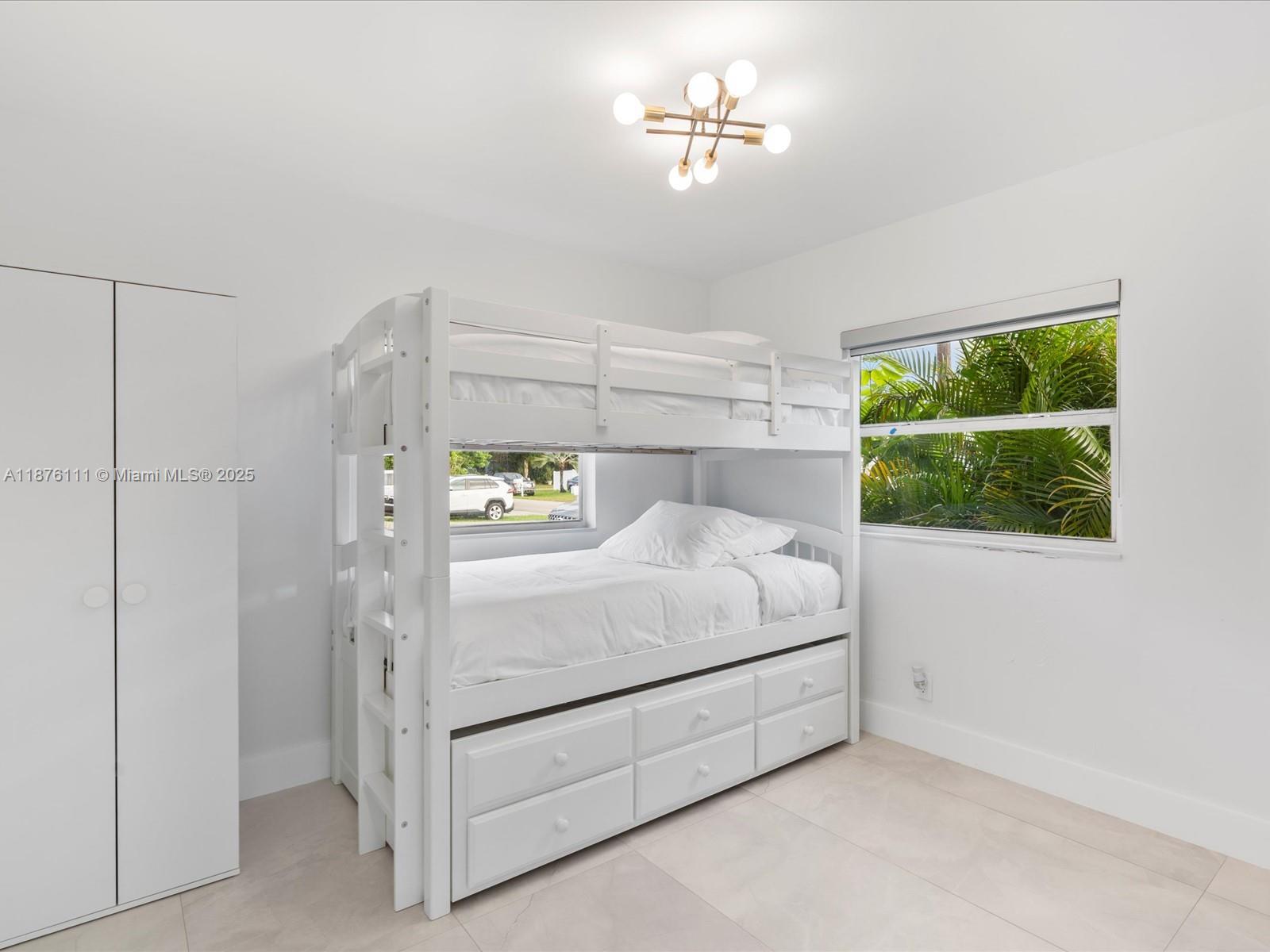 5731 Southwest 54th Terrace Davie, FL 33314 - Photo 14 of 22 a bedroom with a bed and a window