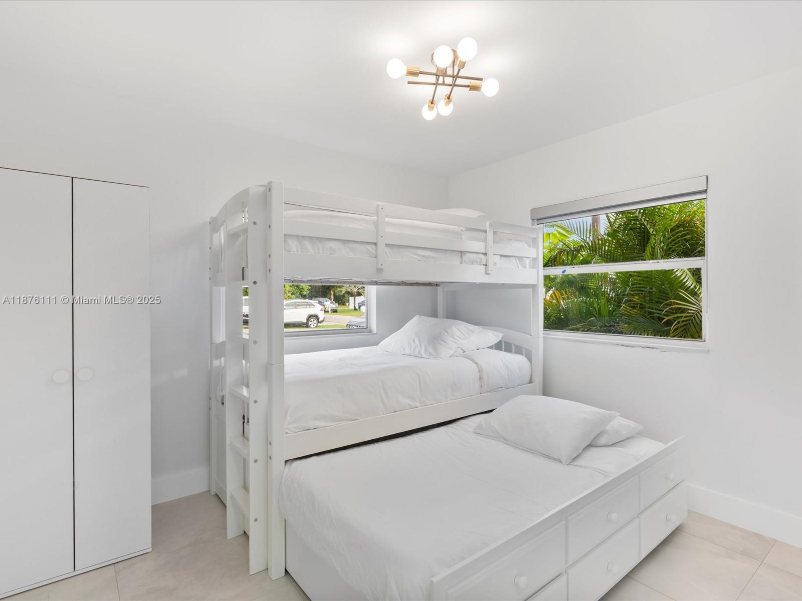 5731 Southwest 54th Terrace Davie, FL 33314 - Photo 15 of 22 a bedroom with a bed and a window