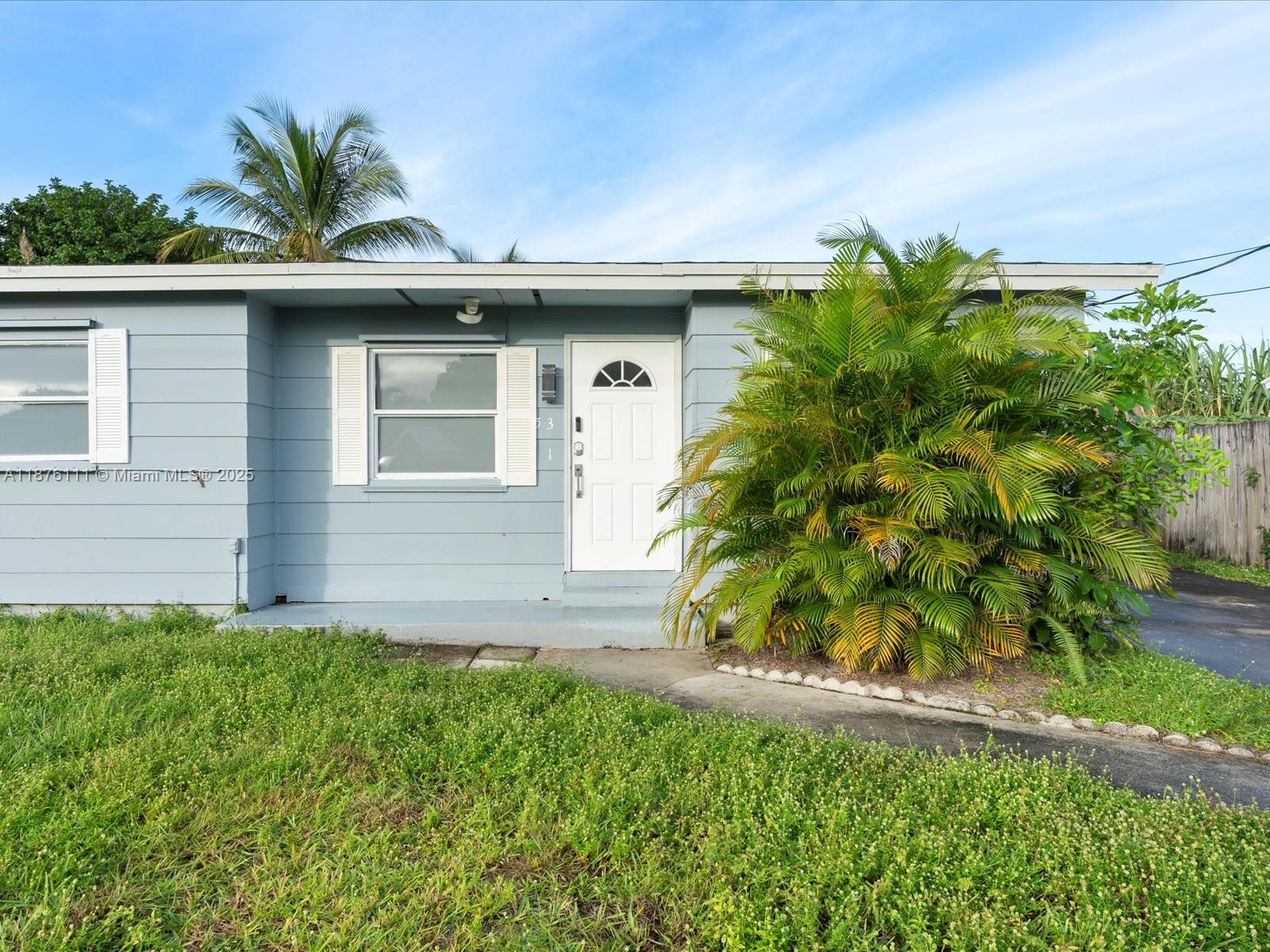 5731 Southwest 54th Terrace Davie, FL 33314 - Photo 4 of 22 a front view of a house with a garden