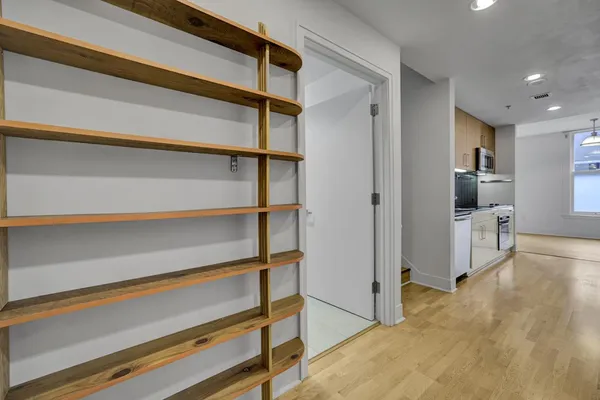 a view of walk in closet with empty racks
