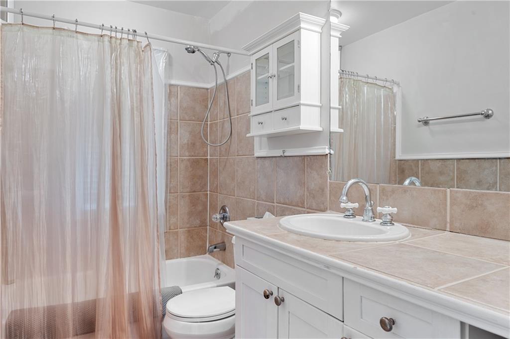 866 Briarcliff Road Northeast, Unit B3 Atlanta, GA 30306 - Photo 12 of 17 a bathroom with a sink a toilet and shower