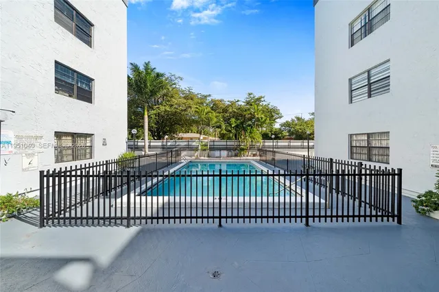 a view of a hallway with white walls and stairs