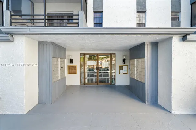 a view of kitchen with sink and refrigerator