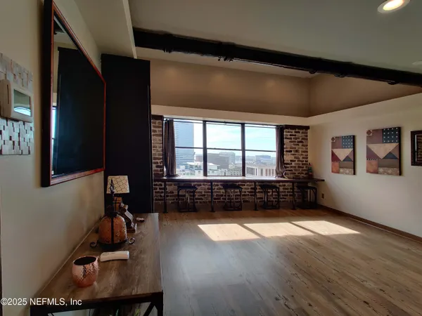 a view of a refrigerator in kitchen and a wooden floor