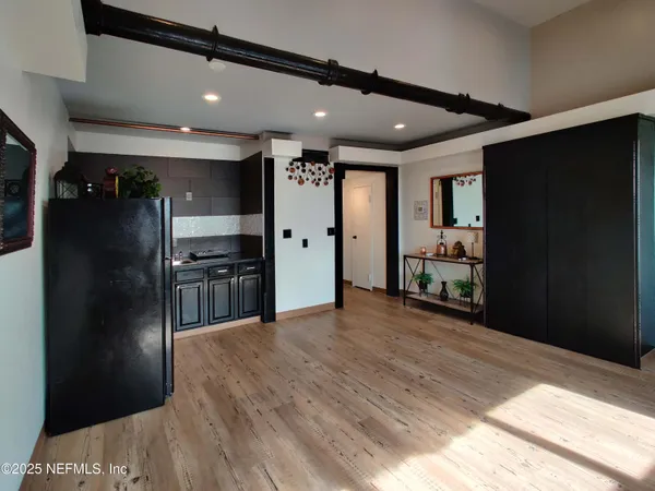 a view of a balcony with floor to ceiling windows with wooden floor
