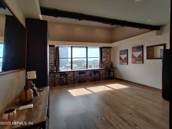 a view of a refrigerator in kitchen and windows