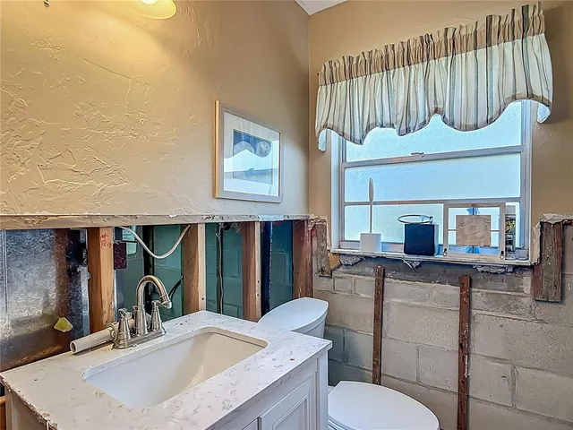 a kitchen with a sink cabinets and appliances