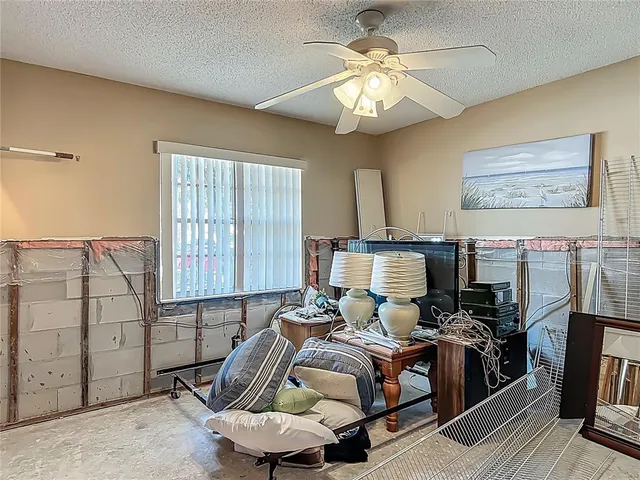 a bed room with a bed furniture and a flat screen tv