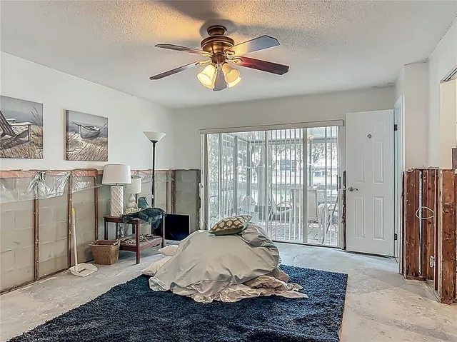 a bedroom with a bed and a painting on the wall