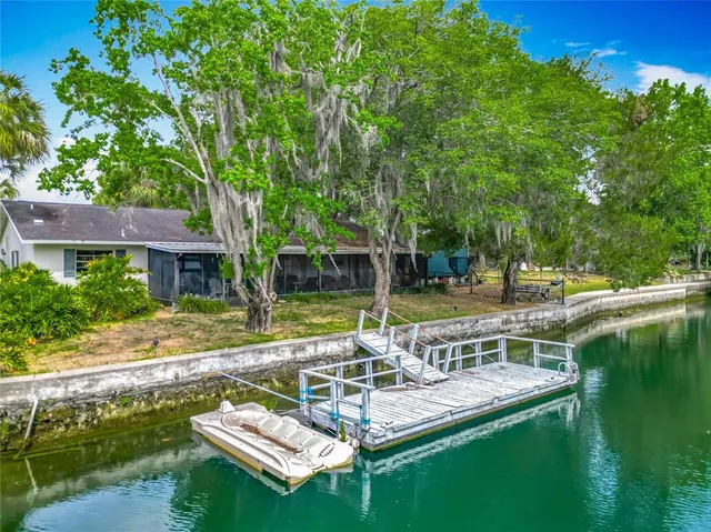 a view of swimming pool with lawn chairs and couches