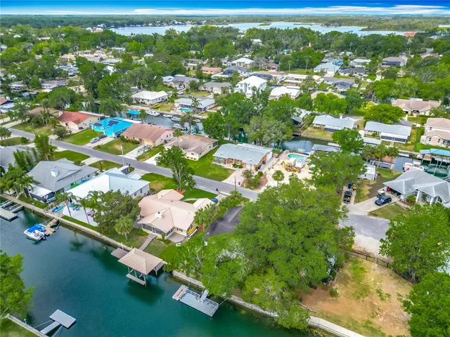an aerial view of residential houses with outdoor space and swimming pool