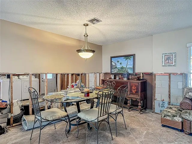 a dining room with furniture and a chandelier