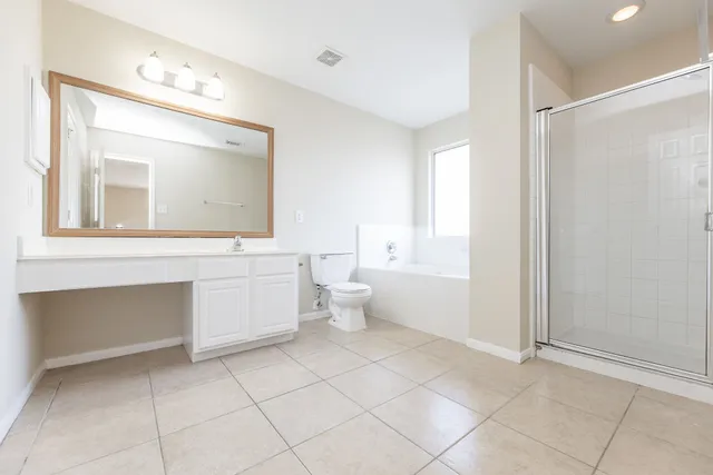a bathroom with a toilet sink and a mirror