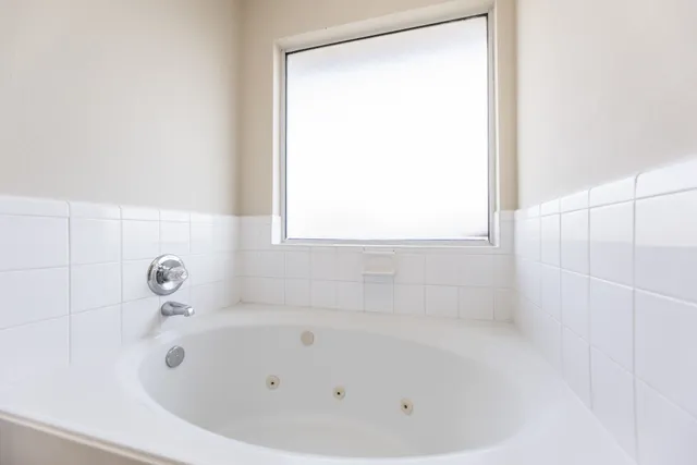 a white bath tub sitting next to a window