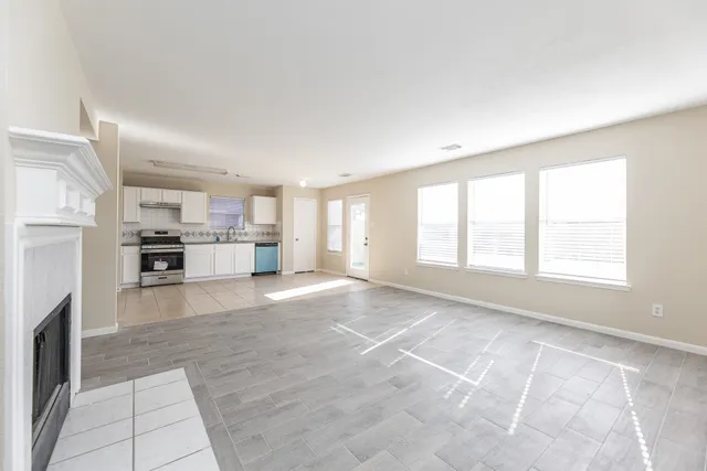 a view of kitchen with kitchen island and stainless steel appliances