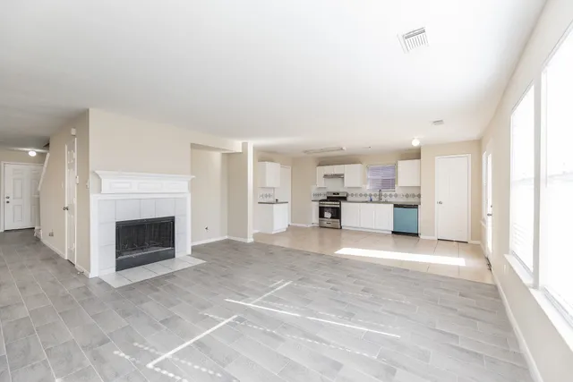 a view of a kitchen with a sink and a fireplace