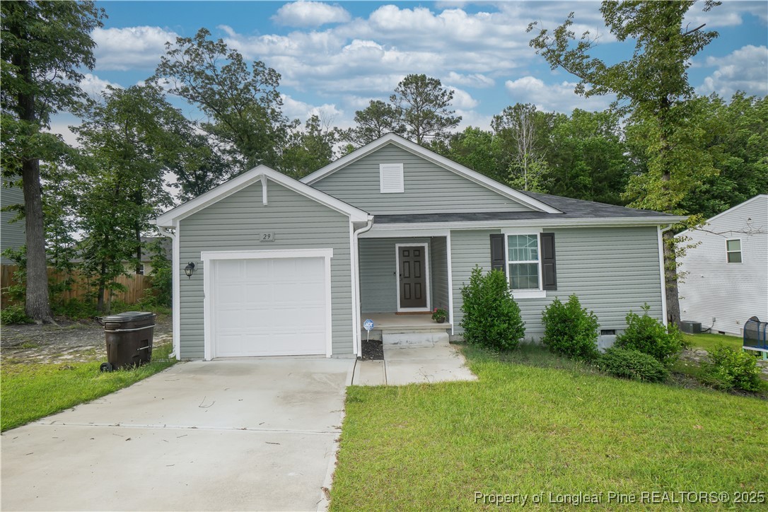 a view of a house with a yard and potted plants