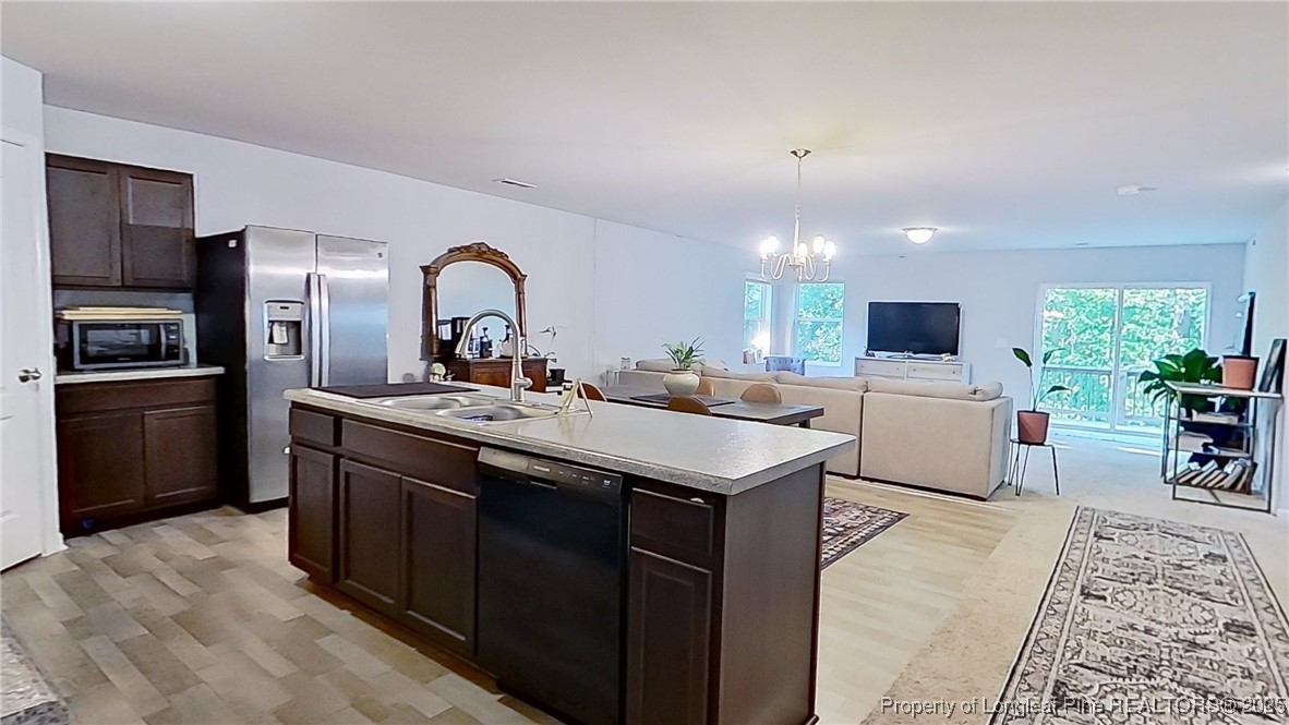 29 York Court Spring Lake, NC 28390 - Photo 13 of 22 a kitchen with stainless steel appliances granite countertop a sink stove and refrigerator