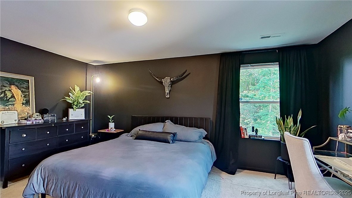 29 York Court Spring Lake, NC 28390 - Photo 15 of 22 a bedroom with a large bed and a potted plant