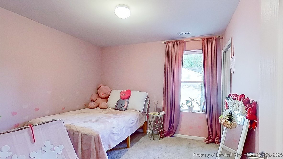 29 York Court Spring Lake, NC 28390 - Photo 17 of 22 a bedroom with a bed and a window