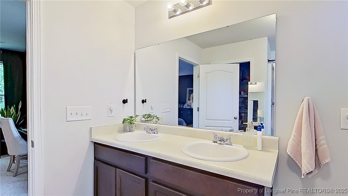 29 York Court Spring Lake, NC 28390 - Photo 19 of 22 a bathroom with a sink and a mirror