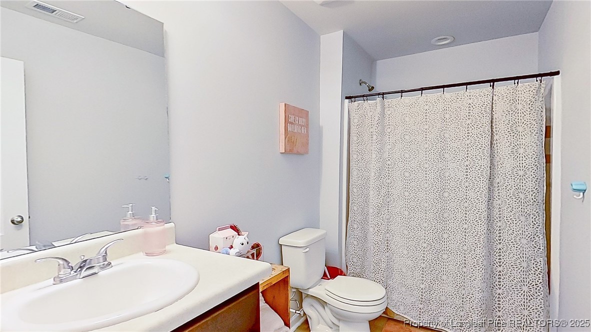 29 York Court Spring Lake, NC 28390 - Photo 20 of 22 a bathroom with a sink and a toilet