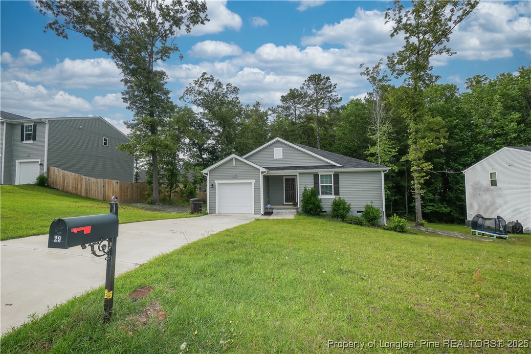 29 York Court Spring Lake, NC 28390 - Photo 2 of 22 a front view of house with yard and green space