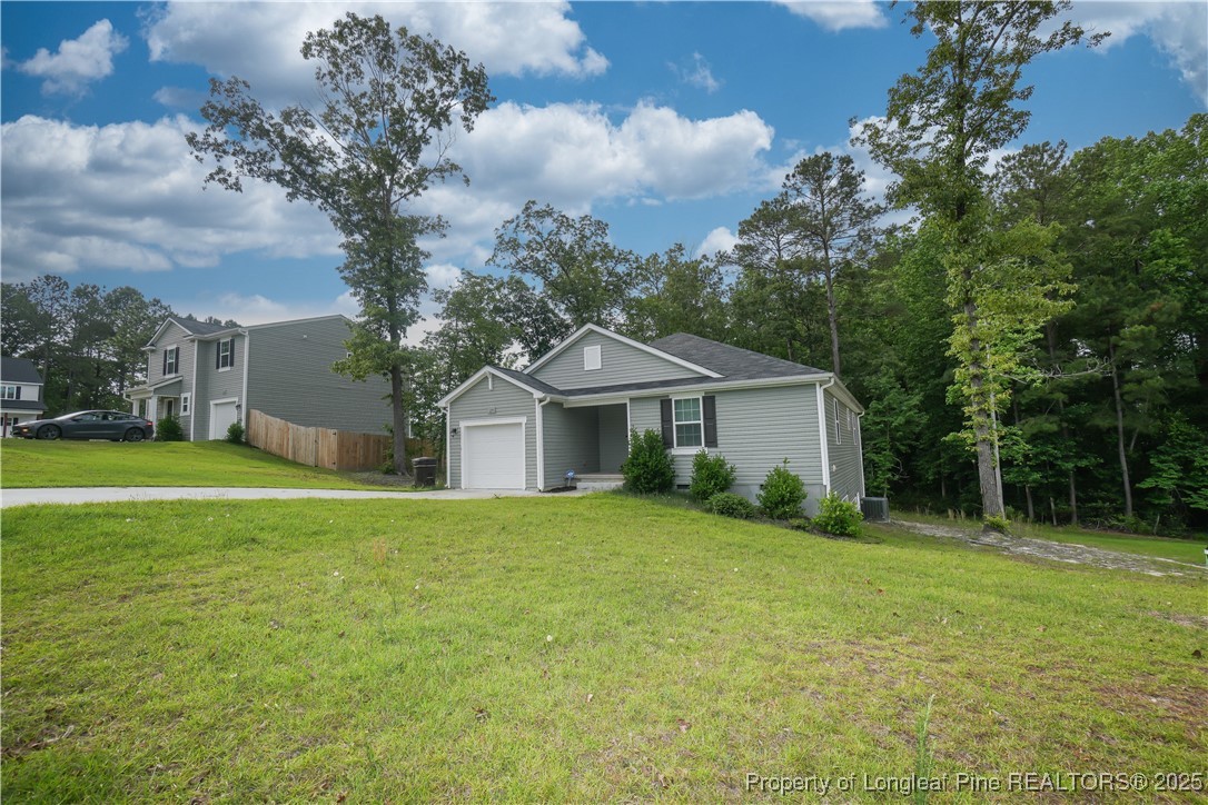 29 York Court Spring Lake, NC 28390 - Photo 3 of 22 a front view of a house with yard and green space