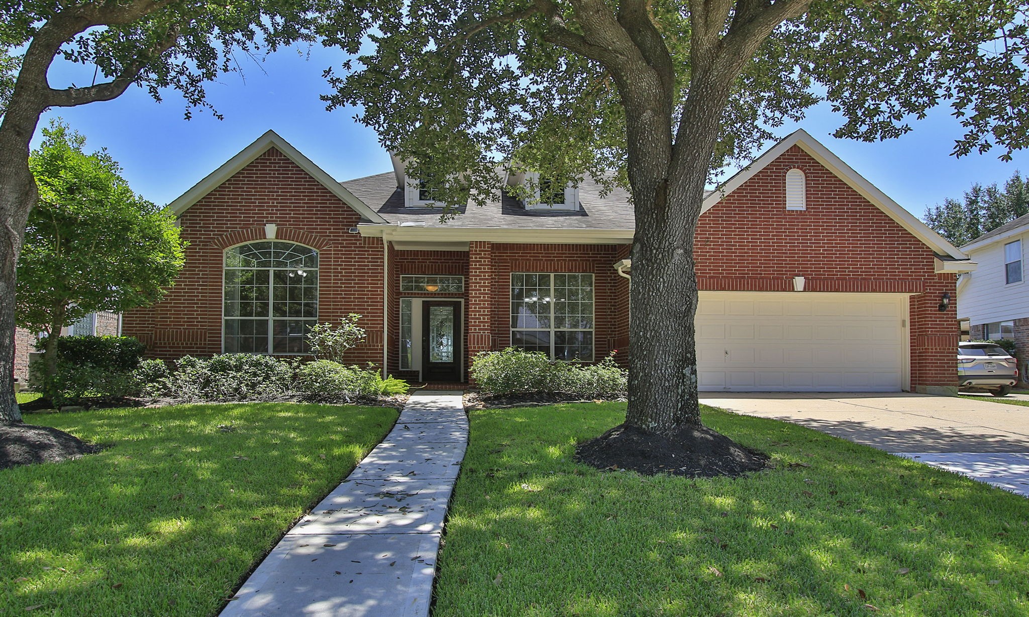 6311 Stone Trail Lane Spring, TX 77379 - Photo 4 of 47 The inviting shaded path leads guests up to the beautiful all-brick home