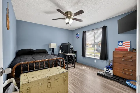 a bedroom with a bed and wooden floor