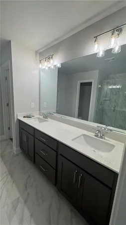 a bathroom with a double vanity sink and a mirror