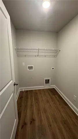 a view of a room with wooden floor