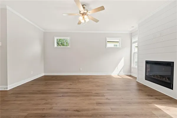 wooden floor in an empty room with a fireplace