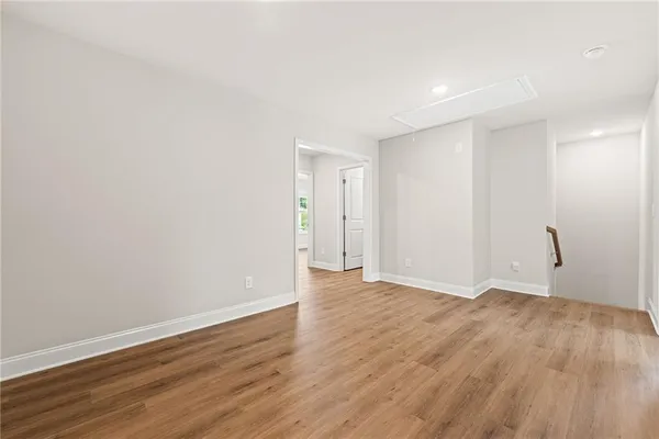a view of an empty room with wooden floor