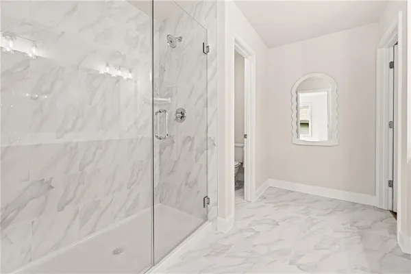 a bathroom with a bathtub and shower