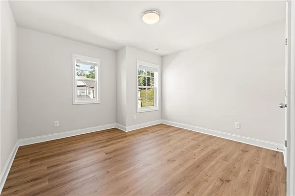 a view of an empty room with wooden floor