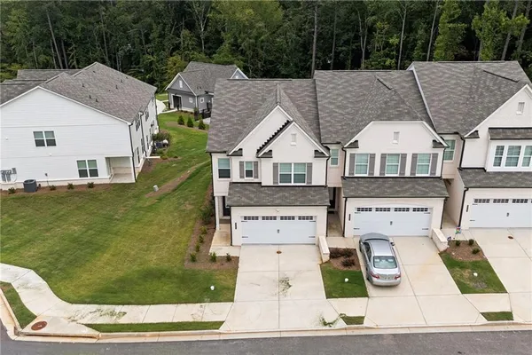 a aerial view of a house with swimming pool garden view and trees