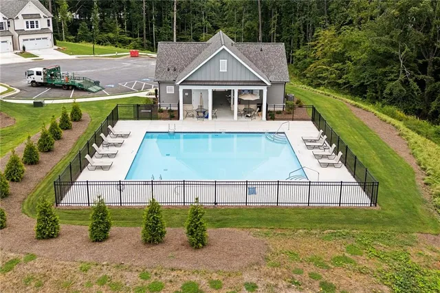 an aerial view of a house with a swimming pool