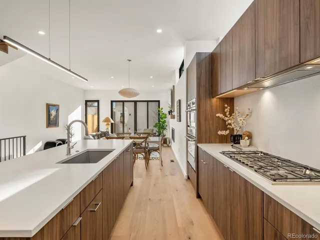 a kitchen with sink stove and cabinets